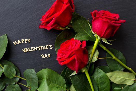 The inscription Happy Valentine and bright red roses
