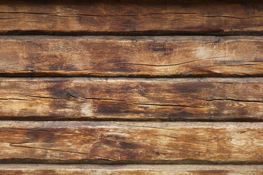 Wooden wall from log as background. Obsolete carpentry boards, panel. Surface of wooden texture for design and decoration. Dark brown horizontal wood plank grunge texture. Rustic backdrop. Copy space.