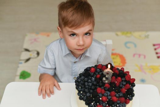 A boy blows out the candles for his birthday