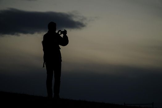 Silhouette of men standing on the hill. Shooting Location: Tokyo Chofu City