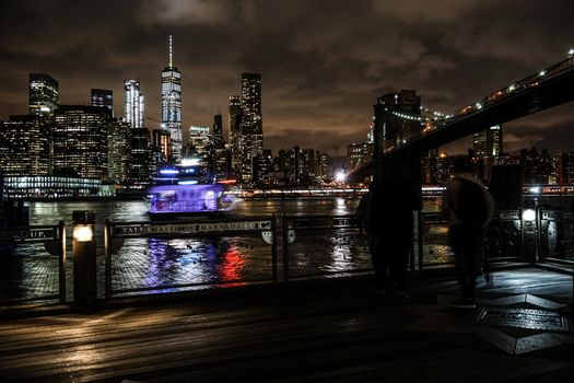 Night view and people of Manhattan and Brooklyn Bridge. Shooting Location: New York, Manhattan