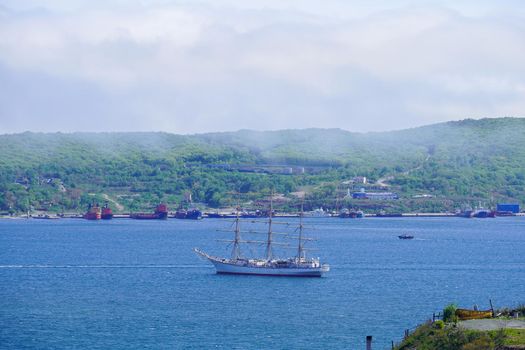 Seascape with a sailboat in the bay of Vladivostok, Russia