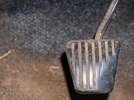 An old car gas pedal with a rubber pad. Foot pedal gas. Part of the mechanism. Part of a vehicle. Press to accelerate the vehicle. Speed set. Rubber wear. Aging process. Car repair. Customer Service.