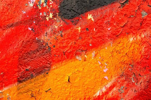 The texture of the painted surface in red and black tones. Multicolored background image. Abstract colored background. Paint aging process. Professional painter. Template for text.