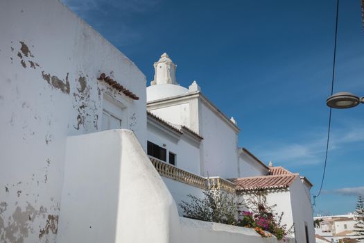 Albufeira, Portugal - May 3, 2018: architecture detail of typical houses in the historic city center on a spring sunny day