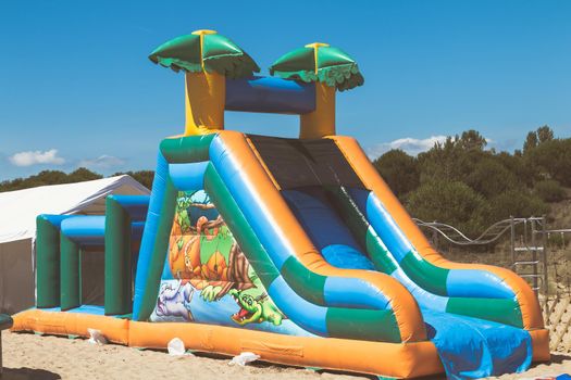 La Faute Sur Mer; France - July 6, 2016: inflatable attraction slide for children installed on the beach on a summer day