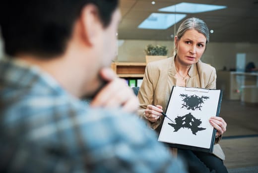 Shot of a mature psychologist conducting an inkblot test with her patient during a therapeutic session