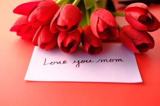 mother day concept with red tulip flower on red background ,