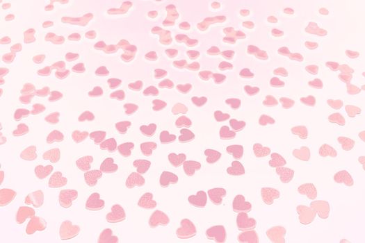 Delicate background with hearts. Beautiful confetti of pale pink heart color fall on a white background. Invitation template Design for background, greeting cards, poster. Valentine's Day