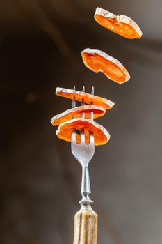 Smoked Chicken meat Sausage sliced flying on the fork. Food levitation