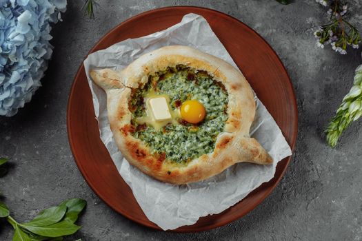 Some khachapuri traditional Georgian homemade cheese and spinach pies on the plate.