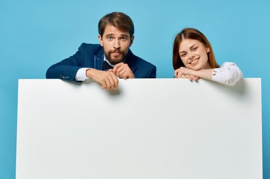 funny man and woman advertising presentation white banner blue background. High quality photo