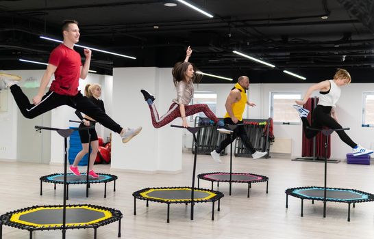 Women's and men's group on a sports trampoline, fitness training, healthy life - a concept trampoline group batut girl healthy, for fit team from sporty and teamwork person, shape beautiful. Studio beauty loss, aerobic