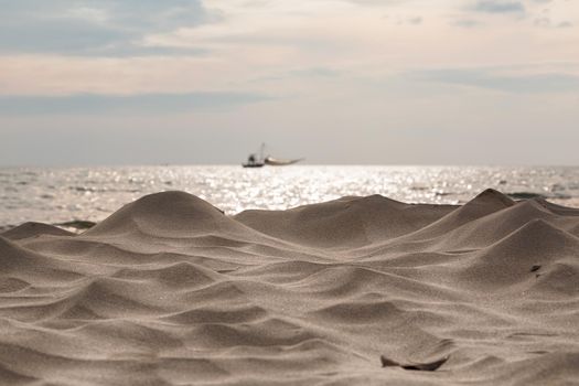 Waves sand creates the wind on the beach