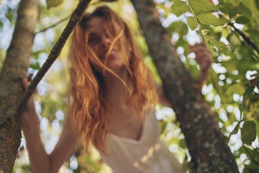 joyful woman in white dress near tree nature summer. High quality photo