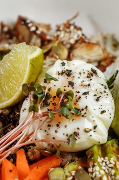 Healthy bowl - quinoa salad with tuna, broccoli, avocado on wooden rustic table. top view.