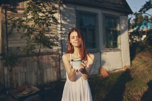 pretty woman with a mug in hand nature stroll. High quality photo