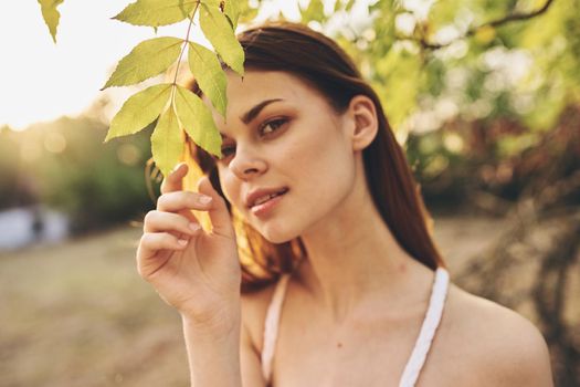 attractive woman outdoors green leaves nature field. High quality photo