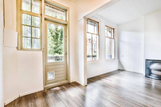 An exciting design of a room with large windows and a door