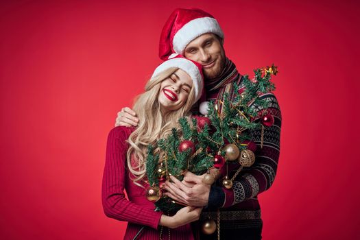 a man and a woman are standing next to the new year tree decoration holiday. High quality photo