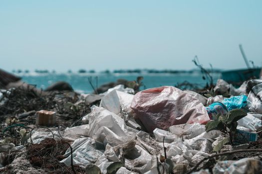 Sea horizon line. Real ocean life climate crisis, nature land pollution. Dirty sand beach, throwing outdoor plastic litter waste, need environmental protection. Problem of garbage caused by man made.