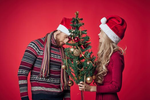 man and woman christmas holiday new year romance red background. High quality photo