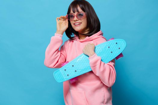 woman blue skateboard posing fun isolated background. High quality photo