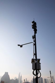 Modern public CCTV camera on pole with urban building in background