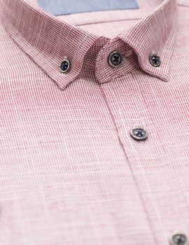 red shirt with a focus on the collar and button, close-up