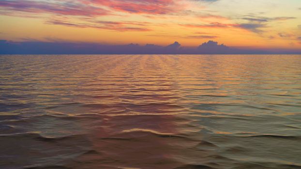 Seascape with a beautiful sunset over the water surface.
