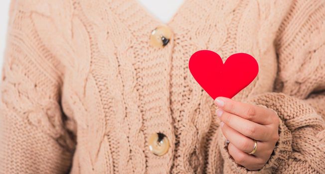 Love Valentine's Day. Woman beauty hands holding red heart for giving help donation medical healthcare concept isolated on white background, holiday background concept