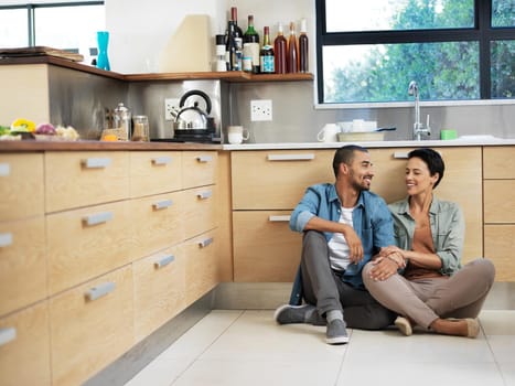 Shot of a smiling young couple sitting together on their kitchen floor