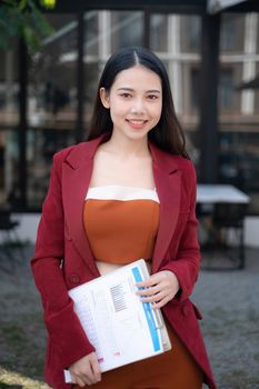 Smiling and happy asian businesswoman looking at camera. Finance and Accounting concept
