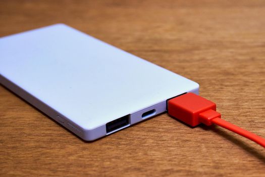 External powerbank with cable and two usb outputs. Powerbank for charging mobile devices