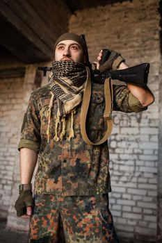 Portrait of serious middle eastern man with AK-47