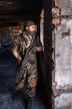 Portrait of serious middle eastern man with AK-47