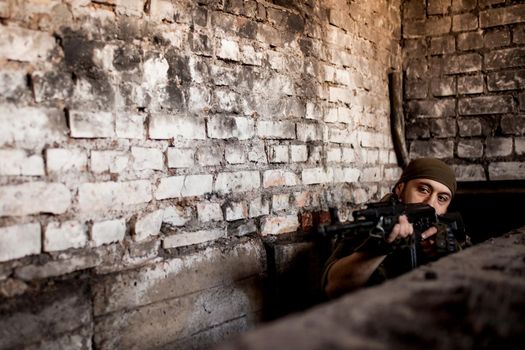 Arab soldier aiming with Kalashnikov AK-47 assault rifle.