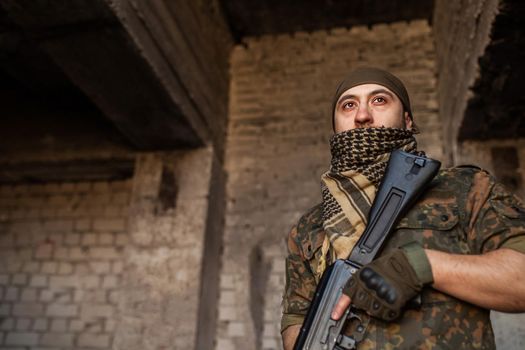 Portrait of serious middle eastern man with AK-47