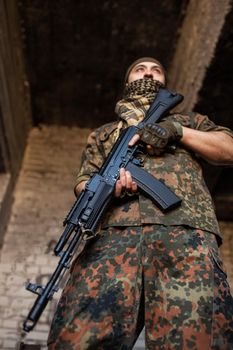 Portrait of serious middle eastern man with AK-47