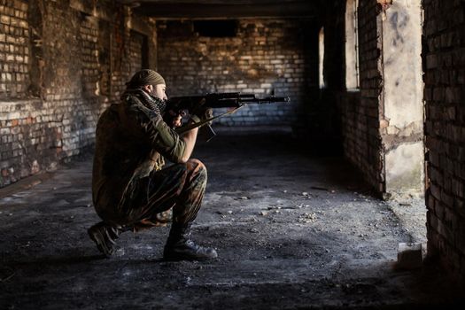 Arab soldier aiming with Kalashnikov AK-47 assault rifle.