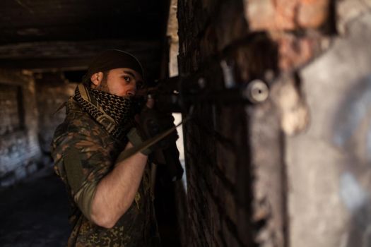 Arab soldier aiming with Kalashnikov AK-47 assault rifle.