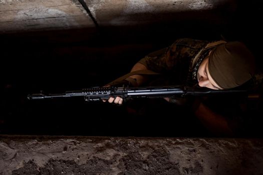 Arab soldier aiming with Kalashnikov AK-47 assault rifle.