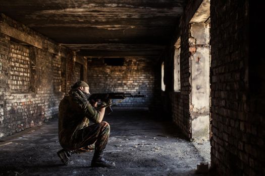 Arab soldier aiming with Kalashnikov AK-47 assault rifle.