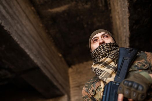 Portrait of serious middle eastern man with AK-47
