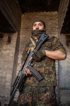 Portrait of serious middle eastern man with AK-47