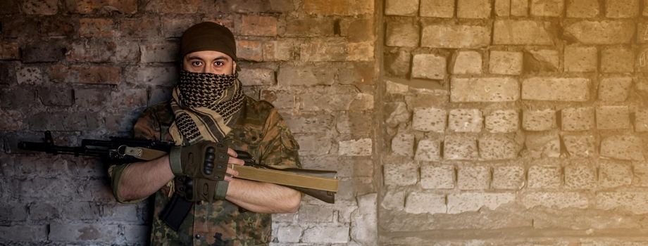 Portrait of serious middle eastern man with AK-47