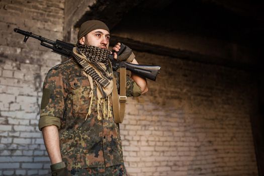 Portrait of serious middle eastern man with AK-47