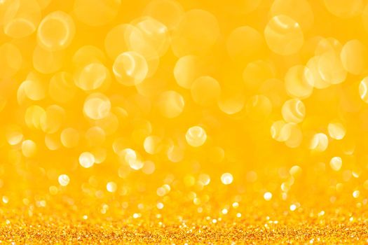 sparkles of yellow glitter abstract background. Copy space.