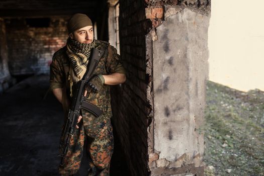 Portrait of serious middle eastern man with AK-47