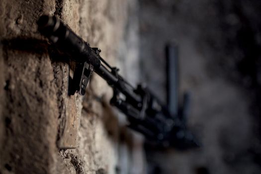 old submachine gun kalashnikov AK-47 against the wall